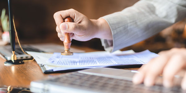 Image of licensing official stamping document for DGA licensing